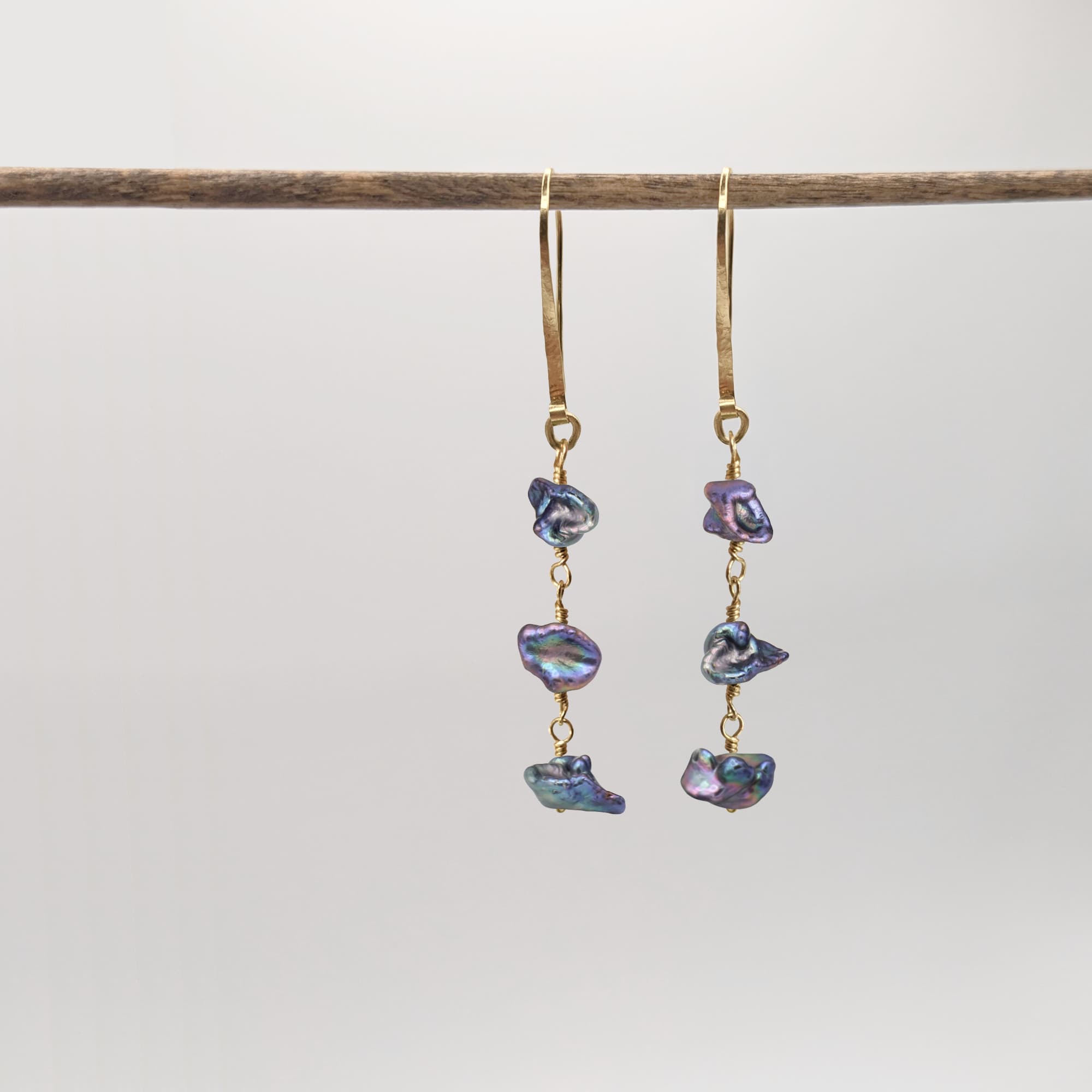Handmade gold earrings with peacock keshi pearls