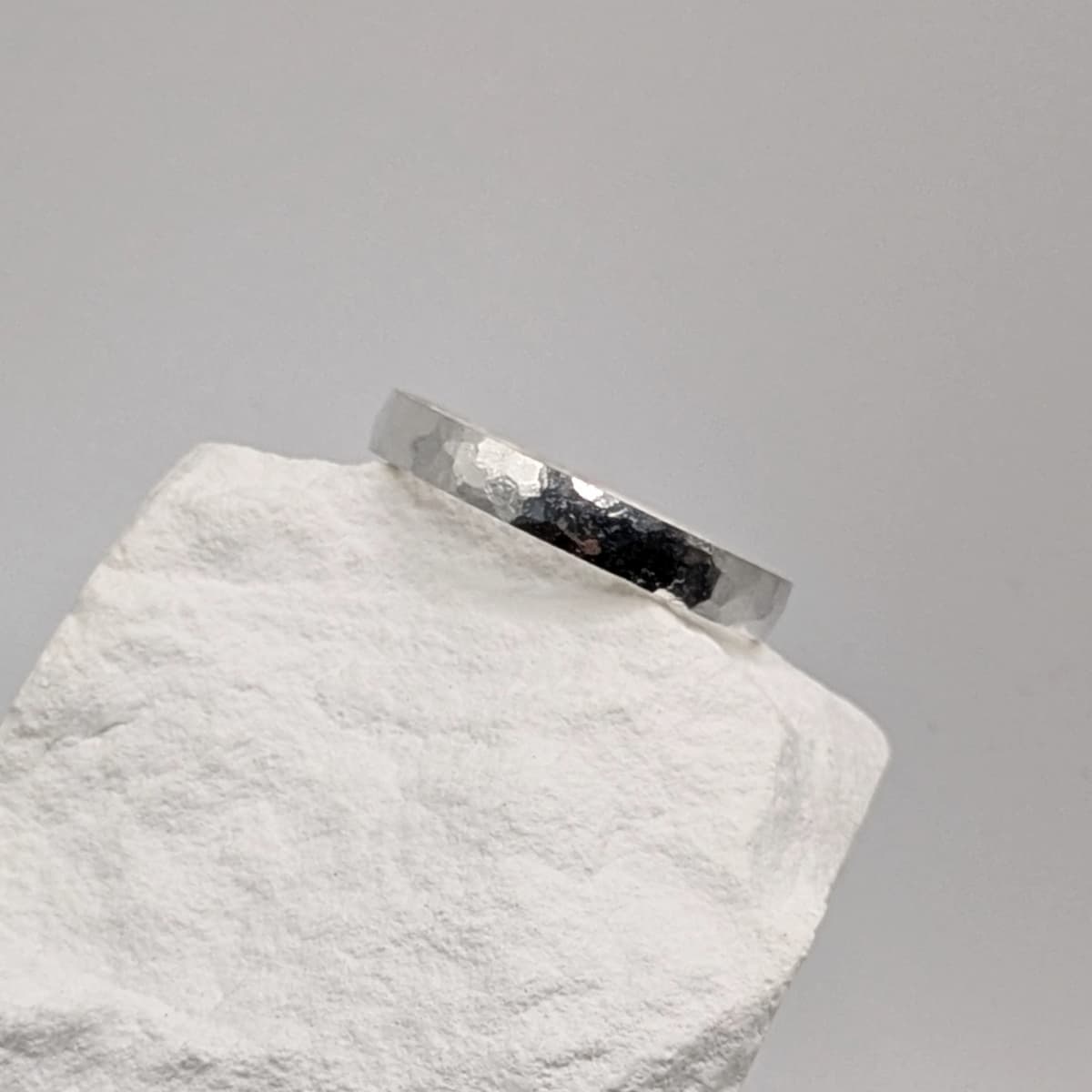 Handcrafted hammered wedding band in platinum